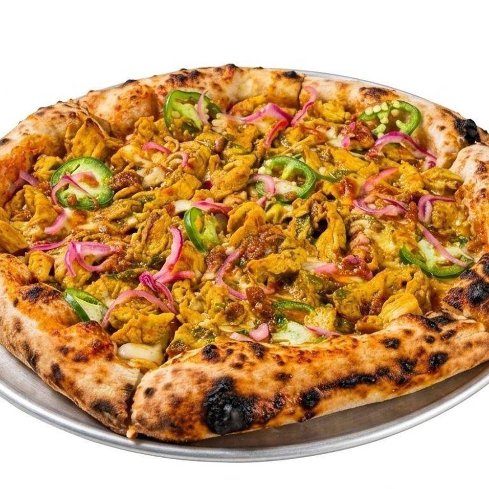 Butter chicken pizza topped with jalapeño and pickled red onion
