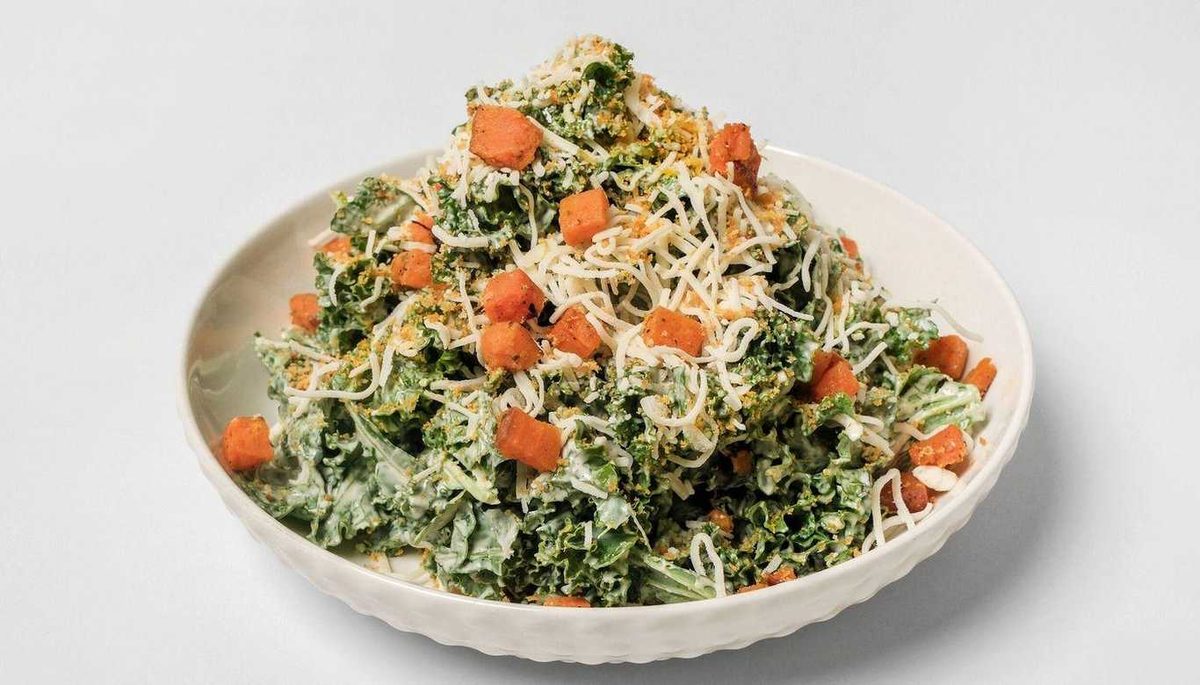 Kale caesar salad with shredded parmesan and croutons